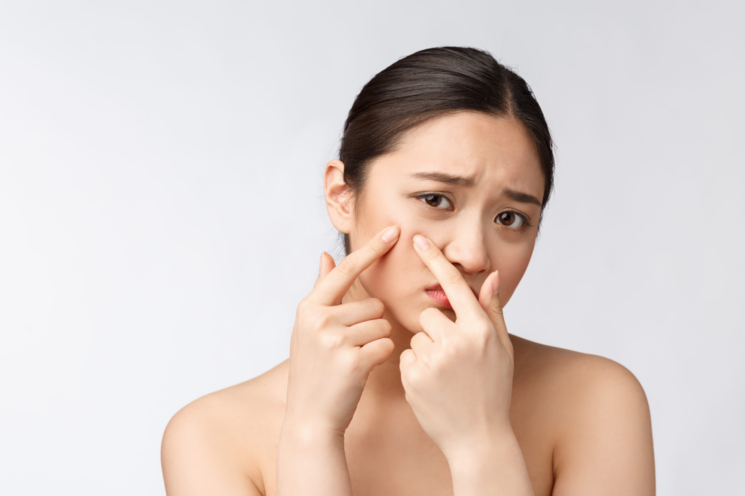 Portrait of senior and young woman Face Skin Problem - young woman unhappy touch her skin isolated, concept for skin care, asian.